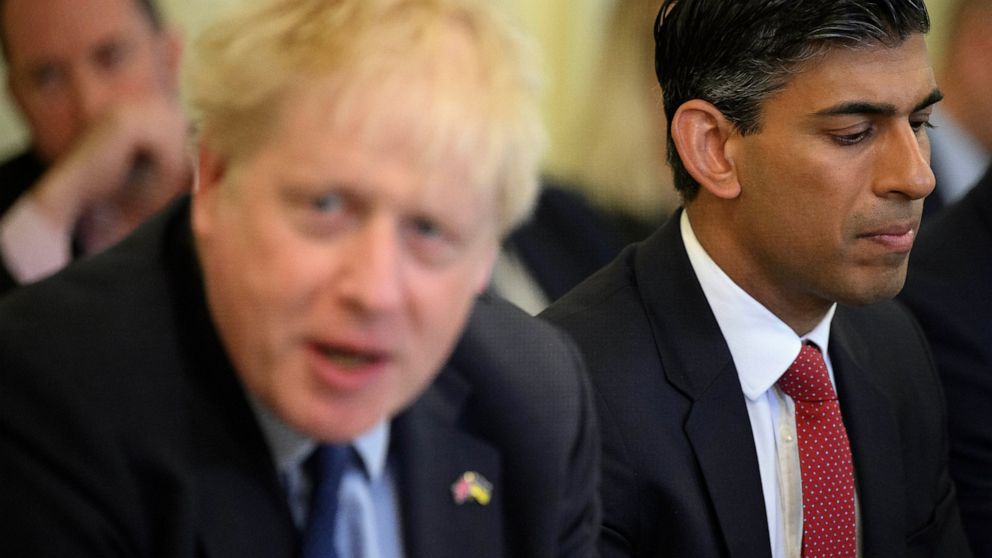 Britain's Chancellor Rishi Sunak, right, listens as Britain's Prime Minister Boris Johnson addresses his Cabinet during his weekly Cabinet meeting in Downing Street on Tuesday, June 7, 2022 in London. Johnson was meeting his Cabinet and trying to pat