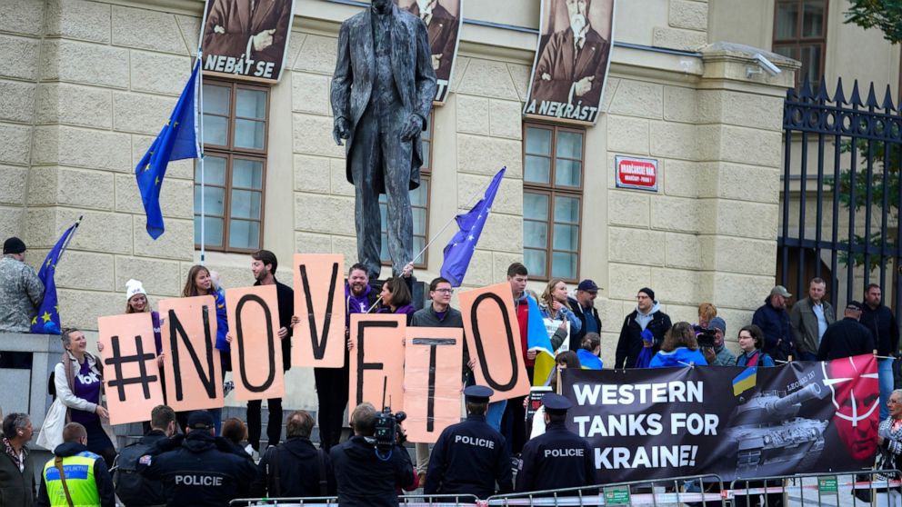 Protestors hold EU flags and banners as they demonstrate outside of an EU Summit at Prague Castle in Prague, Czech Republic, Friday, Oct 7, 2022. European Union leaders converged on Prague Castle Friday to try to bridge significant differences over a